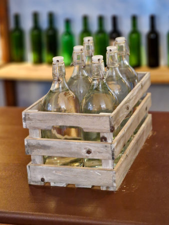 Wooden box with bottles of wine on a table in a restaurantの写真素材