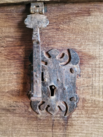 Old rusty keyhole on a wooden door. Antique door handle.の写真素材