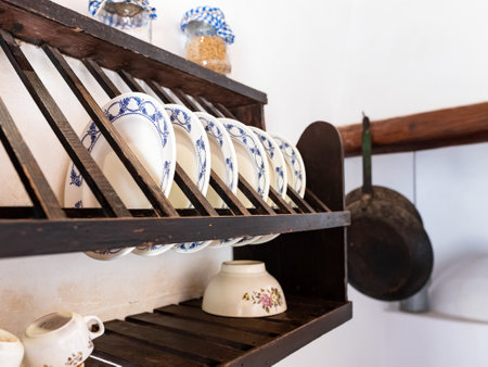 Dishes on the shelf in the kitchen of a country house.の写真素材