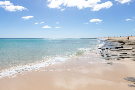 beautiful beach with golden sands and calm waters in Fuerteventura, Corralejo, Canary Islandsの写真素材