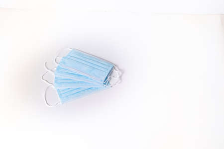 several blue surgical masks on white background