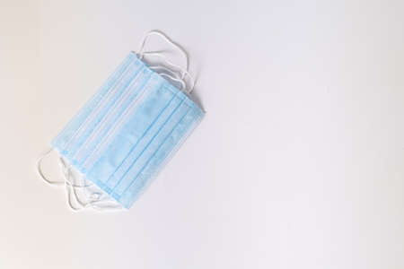 several blue surgical masks on white background