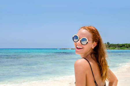 Portrait girl with sunglasses at beachの写真素材