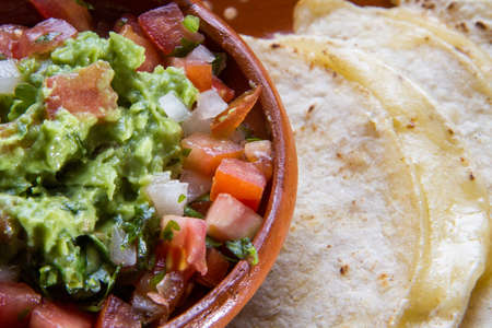 Authentic mexican quesadillas and guacamole sauceの写真素材