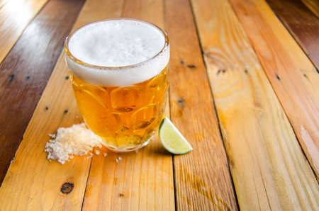 Jar of beer with salt and limeの写真素材