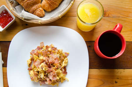 Classic scrambled eggs with ham and coffeeの写真素材