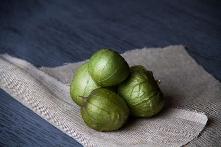Green tomatillos in wood backgroundの写真素材