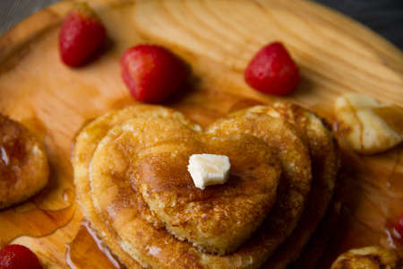 Hot heart pancake with strawberry and maple syrupの写真素材