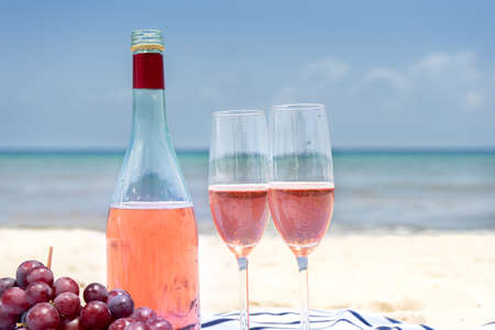 Rose wine in glasses at the beachの写真素材