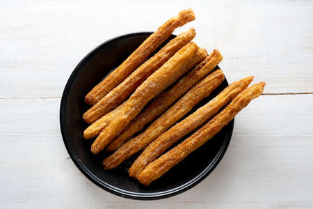 Traditional churros with sugar and chocolateの写真素材