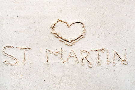 Handwriting words St. Martin on sand of beach