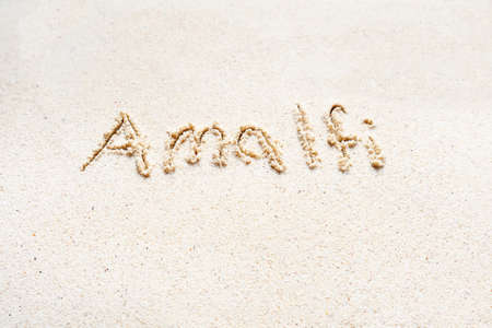 Handwriting words "Amalfi" on sand of beachの写真素材