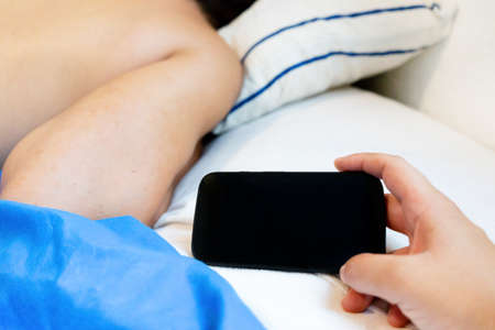 Young woman spying boyfriend mobile phone