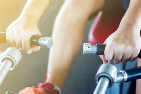 Young man pulling workout machineの写真素材