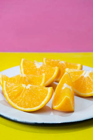 Fresh orange slices on colorful background