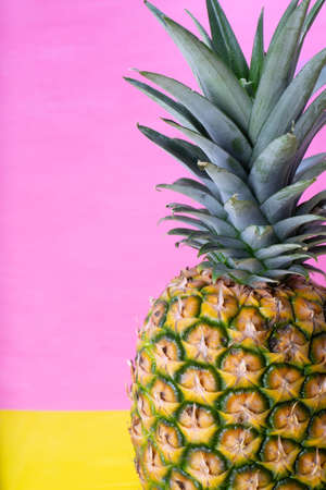 Whole raw pineapple on colorful backgroundの写真素材