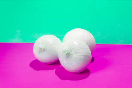 Set of white onions on colorful background