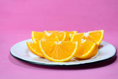 Fresh orange slices on colorful background