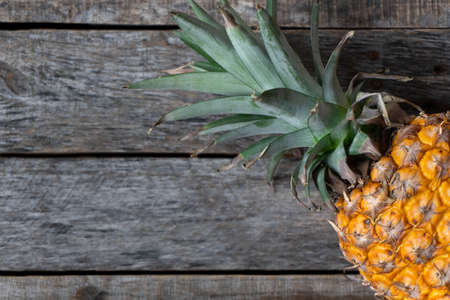 Fresh and colorful pineapple on wood background