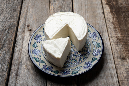 Fresh and tasty mexican panela cheese board on wood background