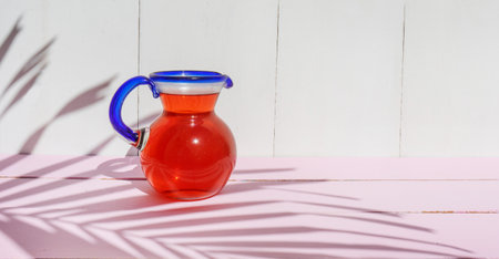 Cold hibiscus water in glass jar on colorful backgroundの写真素材