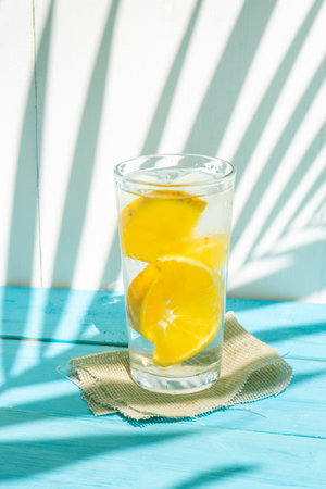 Cold orange water with fresh fruit on colorful backgroundの写真素材