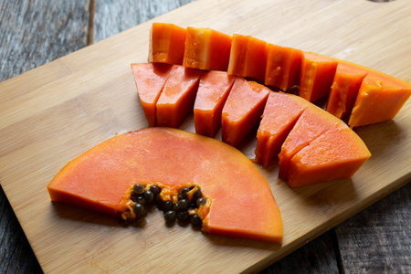 Slice of tasty and juicy papaya with seedsの写真素材