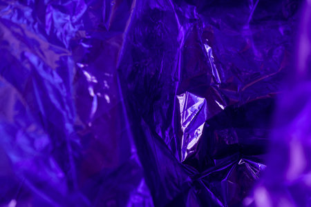 violet wrinkled cellophane paper background textureの写真素材