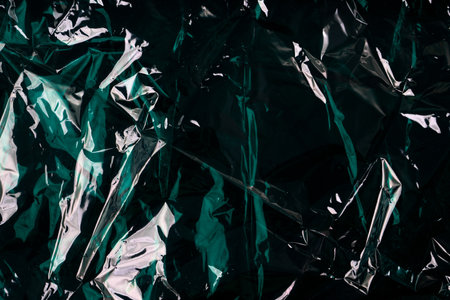 green wrinkled cellophane paper background textureの写真素材