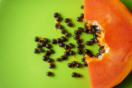 Slice of tasty and juicy papaya with seedsの写真素材