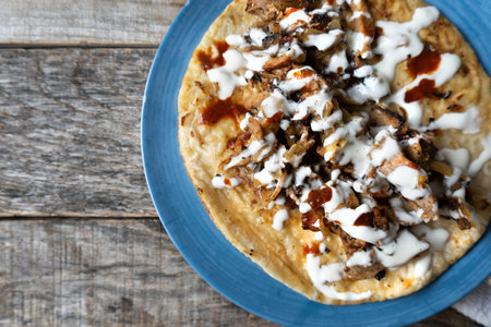 Traditional mexican tacos known as arabes style on wooden background