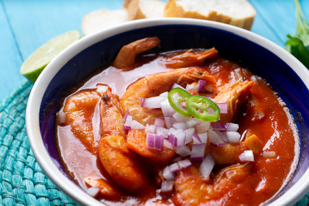 Traditional mexican shrimp soup on blue backgroundの写真素材