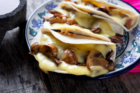 Mexican quesadillas with champignon mushrooms on wooden backgroundの写真素材