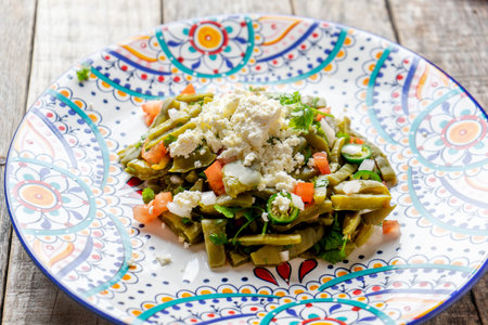 Traditional mexican nopal cactus salad with cheese on wooden backgroundの写真素材