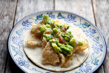 Traditional mexican chicharron taco with guacamole also called "placero"の写真素材