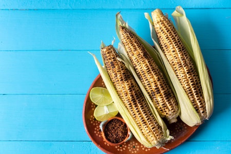 Traditional mexican grilled corn with lime and chili powder