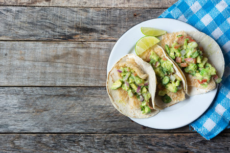 Traditional mexican chicharron tacos with guacamole also called "placeros"の写真素材