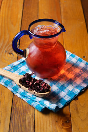 Cold hibiscus tea also called Jamaica water with dried flowersの写真素材