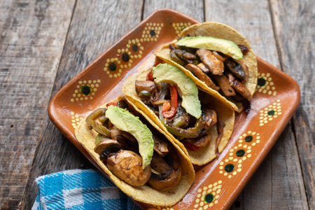 Mexican vegan tacos with avocado and mushrooms on wooden backgroundの写真素材