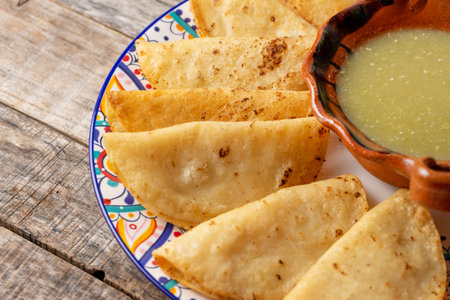 Traditional mexican potato fried tacos on wooden backgroundの写真素材