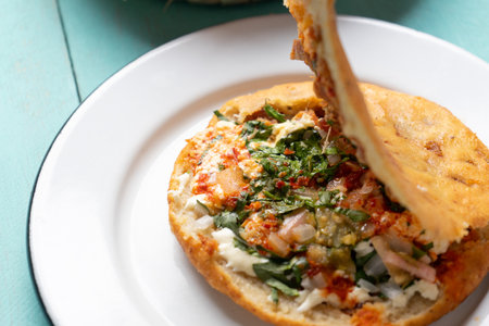 Traditional mexican gorditas with pressed chicharron on turquoise backgroundの写真素材