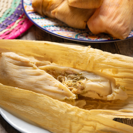 Traditional mexican chicken tamales with green sauce on wooden backgroundの写真素材