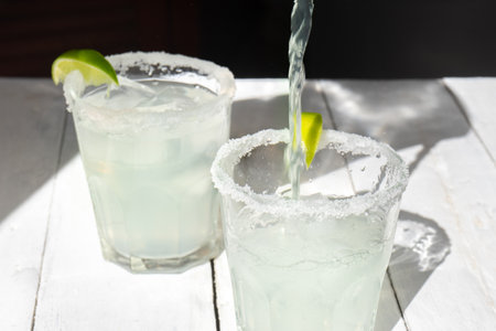 Traditional mexican lime margarita cocktail on white backgroundの写真素材