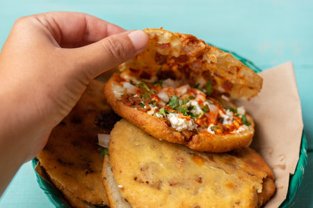 Traditional mexican gorditas with pressed chicharron on turquoise backgroundの写真素材