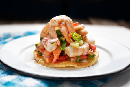Traditional mexican shrimp ceviche toast also called tostada on black background