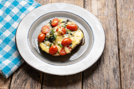 Portobello mushroom stuffed with spinach and cheese on wooden backgroundの写真素材