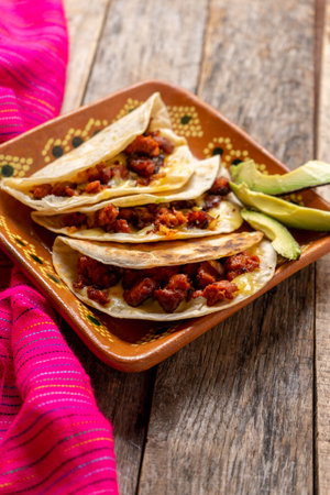 Traditional mexican quesadillas with chorizo on wooden backgroundの写真素材