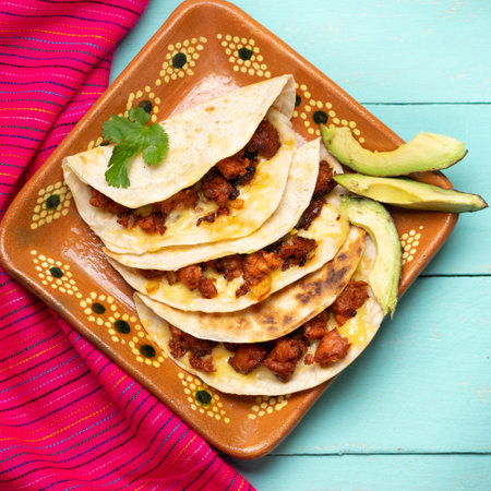 Traditional mexican quesadillas with chorizo on turquoise backgroundの写真素材