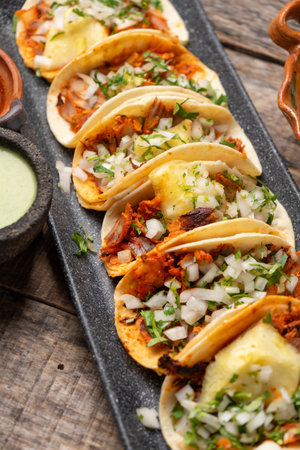 Traditional mexican pork tacos called "Al pastor" with pineapple on wooden backgroundの写真素材