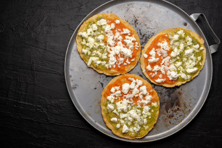 Traditional mexican memela with green and red sauce on dark backgroundの写真素材